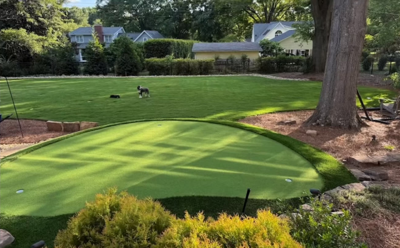 Shaded backyard putting green with landscaping