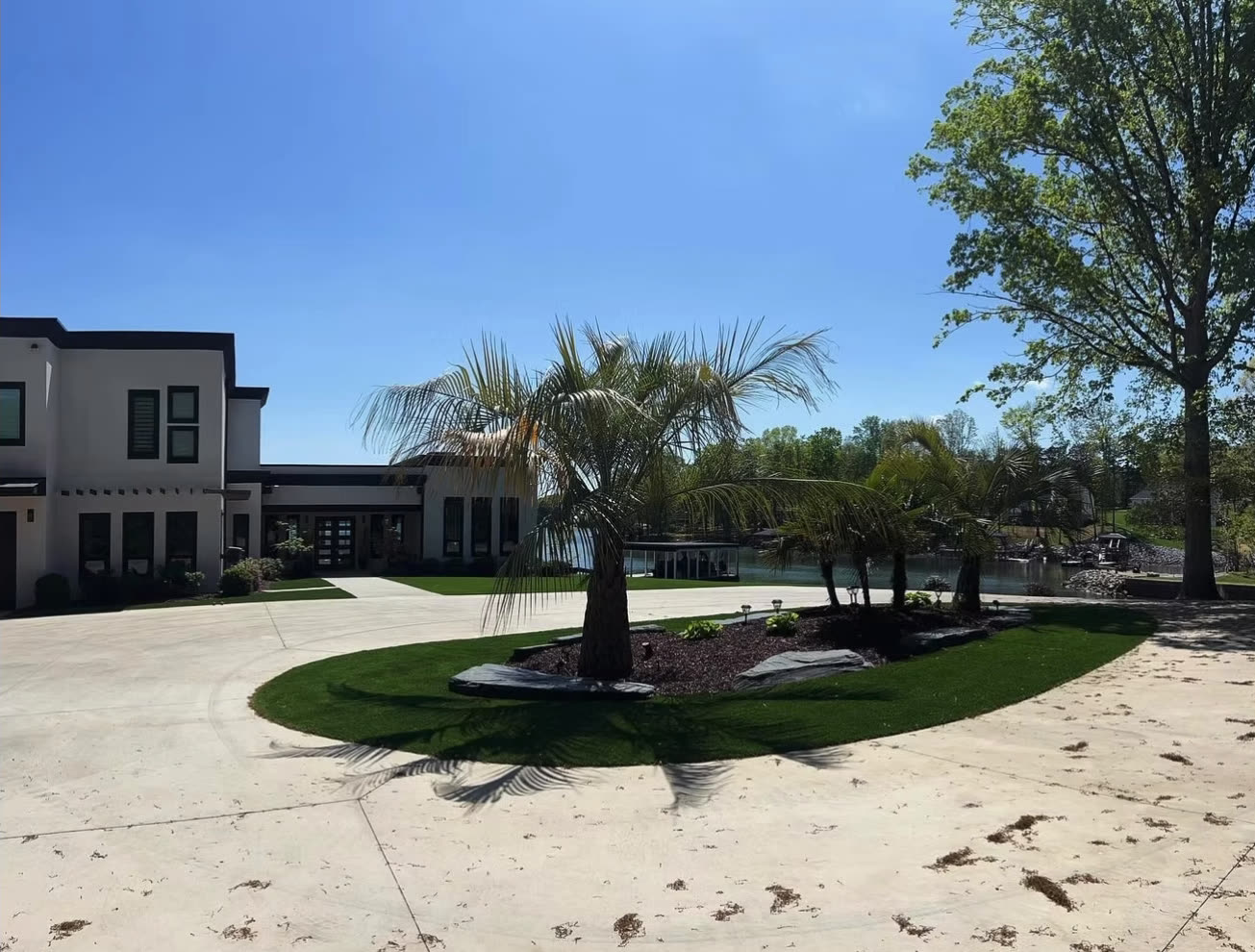 Turf island with a palm tree in a circular driveway